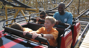 Three young blind boys take a ride on a roller coaster with their mentor Garrick.